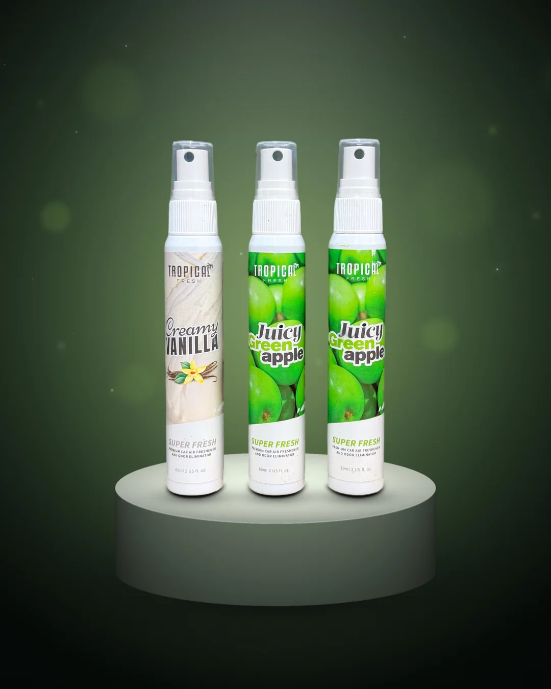 Drie Tropical Fresh autoparfum sprays van 60 ml op een podium, echte productfoto